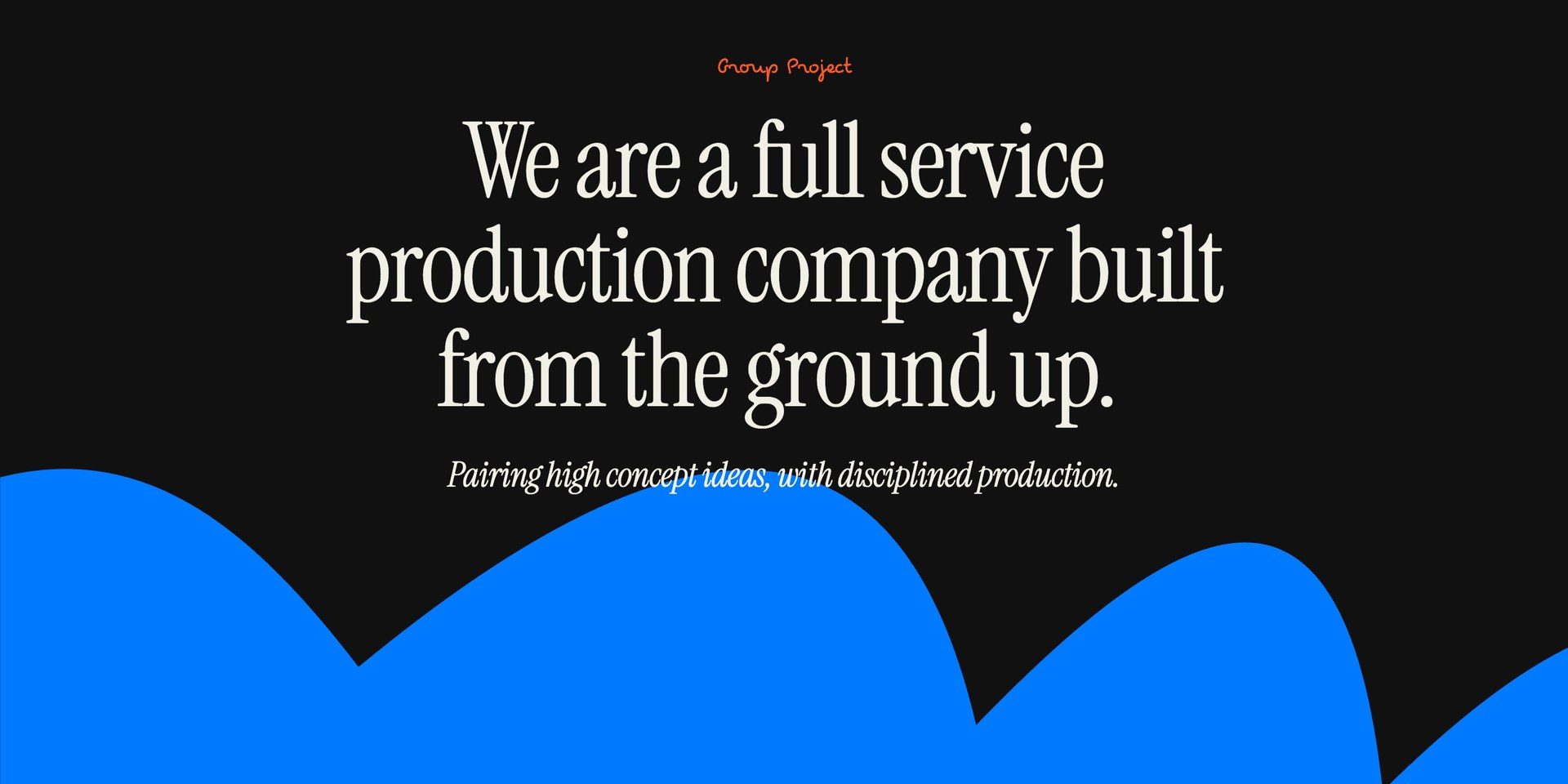 The opening line of the Group Project About page, We are a full service production company built from the ground up, in cream serif on black over the blue scalloped wave.